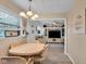 Cozy dining area featuring a stylish chandelier, adjacent to the living room and front entry of the home at 3155 W 57Th St, Indianapolis, IN 46228
