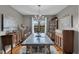 Elegant dining room with a large marble table, chandelier, and decorative china cabinet and artwork at 3155 W 57Th St, Indianapolis, IN 46228