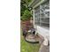 Charming yard featuring mature trees, lush shrubs, and a water fountain adding a touch of elegance to the home's exterior at 3155 W 57Th St, Indianapolis, IN 46228