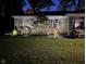 Well-maintained lawn and decorative trees add charm to the home's exterior at 3155 W 57Th St, Indianapolis, IN 46228