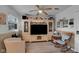 Cozy living room featuring built-in entertainment center, ceiling fan, and decorative accents at 3155 W 57Th St, Indianapolis, IN 46228