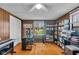 Bright home office with wood floors, a glass desk, custom shelves, and large window providing natural light at 3155 W 57Th St, Indianapolis, IN 46228