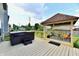 Private backyard deck featuring a hot tub, pergola with seating area, and landscaped surroundings at 3316 Gainesville Ct, Indianapolis, IN 46227