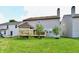 Well-maintained backyard showcasing deck and canopy, grass, and surrounding houses at 3316 Gainesville Ct, Indianapolis, IN 46227