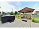 Backyard deck showcasing a hot tub, a covered patio, and a well-maintained lawn, ideal for outdoor activities at 3316 Gainesville Ct, Indianapolis, IN 46227