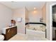 Bathroom featuring a soaking tub, neutral colors, and minimalist decor at 3316 Gainesville Ct, Indianapolis, IN 46227