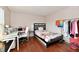 Bedroom with modern desk, shelving and a double bed with floral bedding at 3316 Gainesville Ct, Indianapolis, IN 46227