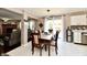 Open concept dining area with modern lighting, a patio view, and easy access to kitchen amenities at 3316 Gainesville Ct, Indianapolis, IN 46227