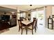 Dining area with a marble table, view of the living room, and access to a modern kitchen at 3316 Gainesville Ct, Indianapolis, IN 46227