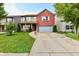 Charming two-story home with a brick facade, attached garage, and manicured lawn at 3316 Gainesville Ct, Indianapolis, IN 46227