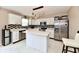 Modern kitchen with sleek appliances, marble countertops, island and stylish black and white backsplash at 3316 Gainesville Ct, Indianapolis, IN 46227