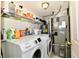 Functional laundry room with modern appliances, storage shelves, and efficient utility systems at 3316 Gainesville Ct, Indianapolis, IN 46227