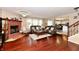 Living room with hardwood floors, brick fireplace, and open floor plan to dining area at 3316 Gainesville Ct, Indianapolis, IN 46227