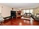 Spacious living room with a brick fireplace, hardwood floors, and comfortable seating at 3316 Gainesville Ct, Indianapolis, IN 46227