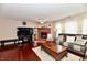 Living room with hardwood floors, brick fireplace, and leather seating area at 3316 Gainesville Ct, Indianapolis, IN 46227
