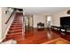 Spacious living room featuring hardwood floors and a staircase with wooden steps at 3316 Gainesville Ct, Indianapolis, IN 46227