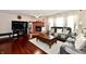 Bright living room featuring hardwood floors, a fireplace, and comfortable sofa set at 3316 Gainesville Ct, Indianapolis, IN 46227