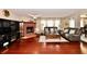 Bright living room features hardwood floors, a cozy brick fireplace, and comfortable sofas for relaxing and entertaining at 3316 Gainesville Ct, Indianapolis, IN 46227