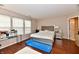 Main bedroom showcasing hardwood floors, a decorative bed, and bright natural light at 3316 Gainesville Ct, Indianapolis, IN 46227