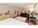 Main bedroom showcasing hardwood floors, a decorative bed, a sofa, and dresser at 3316 Gainesville Ct, Indianapolis, IN 46227