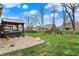 Beautiful backyard featuring covered seating, manicured lawn, and neighborhood views at 3572 Westmore Cir, Bargersville, IN 46106