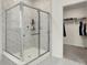 Modern bathroom featuring a glass-enclosed shower with white marble tile and a view of a walk-in closet at 3572 Westmore Cir, Bargersville, IN 46106