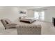 Bright bedroom featuring a comfortable bed, sitting area, and abundant natural light through the large window at 3572 Westmore Cir, Bargersville, IN 46106