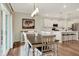 Dining room with wood table and chairs, seamlessly connecting to the kitchen with its inviting island at 3572 Westmore Cir, Bargersville, IN 46106
