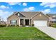 Charming brick ranch with a well-manicured lawn and a two-car garage at 3572 Westmore Cir, Bargersville, IN 46106