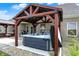 The outdoor hot tub with its pergola features a water fountain at 3572 Westmore Cir, Bargersville, IN 46106