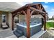 Inviting hot tub with pergola set in a professionally landscaped backyard at 3572 Westmore Cir, Bargersville, IN 46106