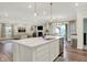 Open concept kitchen features a large island with seating, open to the living and dining rooms at 3572 Westmore Cir, Bargersville, IN 46106
