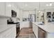 Bright kitchen featuring stainless steel appliances, white cabinetry, quartz countertops, and wood flooring at 3572 Westmore Cir, Bargersville, IN 46106