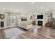 Bright living room featuring a fireplace, plush seating, and natural light at 3572 Westmore Cir, Bargersville, IN 46106