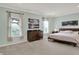 Spacious primary bedroom features a large window, a dark wood dresser, and a dark wood bed frame at 3572 Westmore Cir, Bargersville, IN 46106