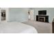 Primary bedroom featuring an electric fireplace, TV, walk-in closet, and ensuite bathroom at 3572 Westmore Cir, Bargersville, IN 46106