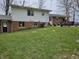 This backyard features a brick and vinyl sided home with a patio seating area and a spacious grassy area at 366 E 200 N, Franklin, IN 46131