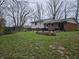 Large backyard featuring a trampoline, patio area with seating, and a garden bed for outdoor enjoyment at 366 E 200 N, Franklin, IN 46131