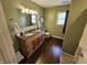 Bathroom with a double vanity, granite countertop, wooden cabinets, and tile flooring, plus neutral paint at 366 E 200 N, Franklin, IN 46131