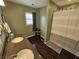 Well-lit bathroom features a double sink, granite countertop, and a shower with a stylish striped curtain at 366 E 200 N, Franklin, IN 46131