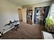 Cozy bedroom featuring a bookshelf, closet space with blue drapes, and space for a keyboard and seating at 366 E 200 N, Franklin, IN 46131