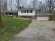 Charming two-story home with a brick and white wood facade, a gravel driveway and a two car garage at 366 E 200 N, Franklin, IN 46131
