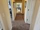 Hallway with carpet, neutral paint, white trim, and an open view into the living area at 366 E 200 N, Franklin, IN 46131