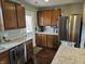 Well-lit kitchen with stainless steel appliances, granite countertops, wood cabinets, and access to the backyard at 366 E 200 N, Franklin, IN 46131