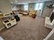 Cozy living room featuring a sectional sofa, fireplace, and playroom area at 366 E 200 N, Franklin, IN 46131