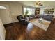 Cozy living room with hardwood floors, natural light, comfortable sofas, a ceiling fan, and neutral paint at 366 E 200 N, Franklin, IN 46131