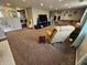 Spacious living room with brown carpet, sectional sofa, and comfortable recliner at 366 E 200 N, Franklin, IN 46131