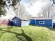 Exterior of house with a view of the lush green yard and wood privacy fence at 404 W Green St, Lebanon, IN 46052