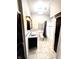 Bathroom featuring a vanity sink, tile floor, a bathtub with a shower curtain, and modern lighting at 404 W Green St, Lebanon, IN 46052