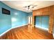 Bedroom with hardwood flooring, modern ceiling fan, and a wall of wood panels at 404 W Green St, Lebanon, IN 46052